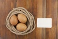 Brown three egg in a nest of twine for Happy Easter Royalty Free Stock Photo