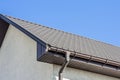 Brown Tiled roof of the house with windows on a background of blue sky Royalty Free Stock Photo