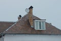 Brown tiled roof of a private house with a large window Royalty Free Stock Photo