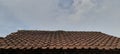 brown roof tiles during the day against a cloudy sky background Royalty Free Stock Photo