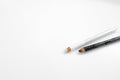 Lip pencil and eye liner makeup on a white background Royalty Free Stock Photo
