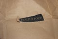 Brown torn paper with words Healthy Food. Natural food concept