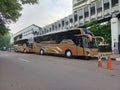 Brown Tour Buses Are Parked Beside The Sidewalk in Jakarta City Royalty Free Stock Photo