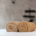 brown towels rolls on bed sheet in the hotel
