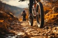 Brown trail Close up of mountain bikes rear wheel and riders foot