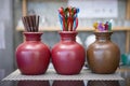 Brown tube and colorful mini spoon in the ceramic vase