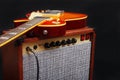Brown tube combo for electric guitar with honey sunburst guitar on black background Royalty Free Stock Photo
