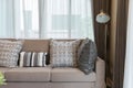 Brown tweed sofa with grey pillows Royalty Free Stock Photo