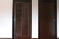 Brown two door close with white wall in new house. wooden laminate floor in living room Royalty Free Stock Photo