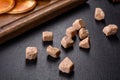 Brown unrefined cane sugar cubes on dark background Royalty Free Stock Photo