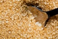 Brown, unrefined sugar and a silver spoon in it Royalty Free Stock Photo