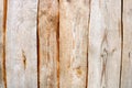 Brown vertical texture of wooden logs, boards with knots, cracks and beautiful patterns of wood fibers Royalty Free Stock Photo