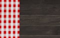 Brown vintage wooden table with red checker napkin. Checkered fabric and wooden dark background. Decoration kitchen towel. Table w Royalty Free Stock Photo