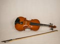 Brown violin with four strings and a violin bow Royalty Free Stock Photo