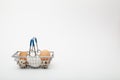 Brown and white chicken eggs in a shopping basket isolated on a white background