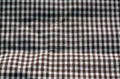 Brown and white color checked fabric texture in blur effect