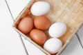 Brown and white eggs on light wooden background. top view Royalty Free Stock Photo