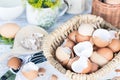 Brown and white eggshells placed in basket in home kitchen on table, eggshells stored for making natural fertilizers Royalty Free Stock Photo