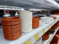 Brown and white flower pot watering tray in the horticulture section of a hypermarket