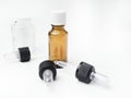 Brown and white medicine glass bottles with dropper isolated over white
