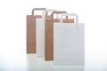 Brown and white paper shopping bags on white background Royalty Free Stock Photo