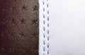 Brown and white perforated leather texture background. White and Brown Leather with stitching close up. Macro shot of shiny leathe