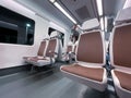 Brown white seats in the interior of a train wagon Royalty Free Stock Photo