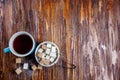 Brown and white sugar in plate or dish and tea in a cup. Objects stand on wooden table. Empty copy space for inscription Royalty Free Stock Photo