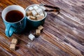 Brown and white sugar in plate or dish and tea in a cup. Objects stand on wooden table. Empty copy space for inscription Royalty Free Stock Photo