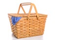 A brown wicker picnic basket on a white background with gingham cloth Royalty Free Stock Photo