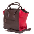 Brown women`s bag with red inserts on the sides, with handles and with a belt, on a white background Royalty Free Stock Photo