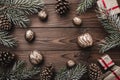 Brown wood background. Fir branches, cones and decorative walnuts. Gifts for xmas. Christmas greeting card and new year. Royalty Free Stock Photo