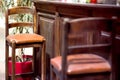 Brown wood bar stool with high legs and leather seat. Royalty Free Stock Photo