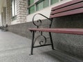 Brown wood bench or chair in front of the office with brick wall. Royalty Free Stock Photo