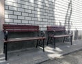 Brown wood bench or chair in front of the office with brick wall. Royalty Free Stock Photo