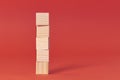 Brown wood bricks tower. construction from wooden cubes. on a red background Royalty Free Stock Photo