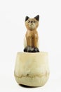 brown wood cat statue on coconut shell isolated on white background Royalty Free Stock Photo