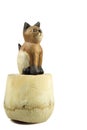 brown wood cat statue on coconut shell isolated on white background Royalty Free Stock Photo
