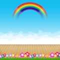 Brown wood floor with flower and blue sky rainbow background Royalty Free Stock Photo