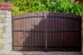 Brown wood portal high natural wooden gate of private house in suburb area Royalty Free Stock Photo