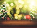 Brown Wood table top with abstract blur christmas tree background with bokeh light,Holiday backdrop,Mock up for display or Royalty Free Stock Photo