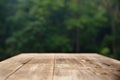 Brown wood table top on a green blur abstract background Royalty Free Stock Photo