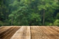 Brown wood table top on a green blur abstract background Royalty Free Stock Photo