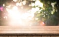 Brown wood table top on a green blur abstract background. Royalty Free Stock Photo