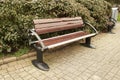 Brown wooden bench with a green meadow in the background. Lonely chairs on the lawn in the park. Royalty Free Stock Photo