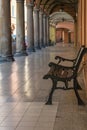 Brown wooden bench in the orange gallery with columns