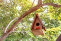 brown wooden birdhouse hanging from tree with natuur Royalty Free Stock Photo