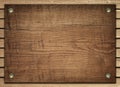Brown wooden board screwed on planks wall Royalty Free Stock Photo