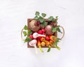 Brown wooden box full of fresh organic vegetables from the local market on a white table Royalty Free Stock Photo