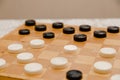 Brown wooden chessboard with classic checkers. Table game. Checkers on the playing field for the game Royalty Free Stock Photo